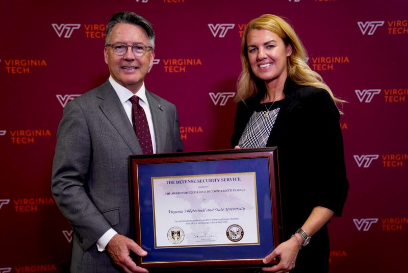 President Tim Sands (left) received the 2018 Award for Excellence in Counterintelligence for Virginia Tech. Carrie Wibben (right), deputy director for the Defense Counterintelligence and Security Agency, presented the award to the university on Aug. 19 in Blacksburg.