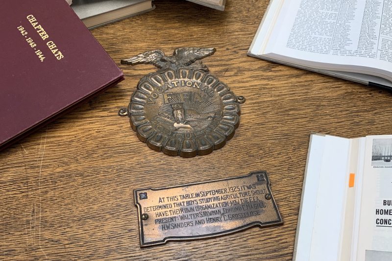 "At this table, in September 1925, it was determined that boys studying agriculture should have their own organization, now the F.F.A. Present: Walter S. Newman, Edmund C. Magill, H.W. Sanders and Henry C. Groseclose," reads the brass plaque on the oak table.
