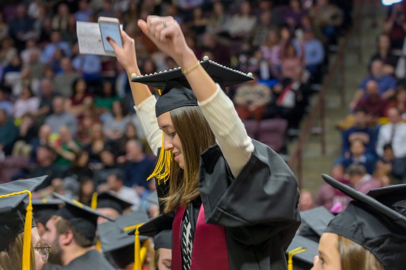 A graduate celebrates her accomplishment. 