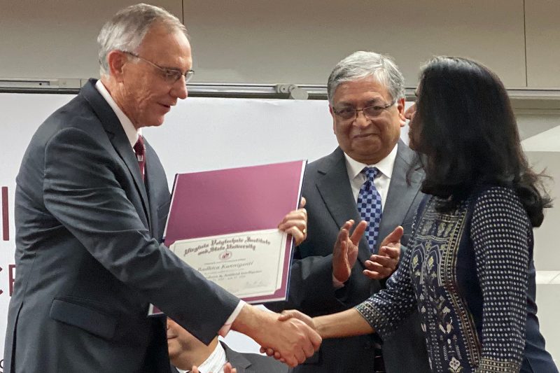 Provost at left hands certificate to Kanniganti with Dr. Sen also pictured at right