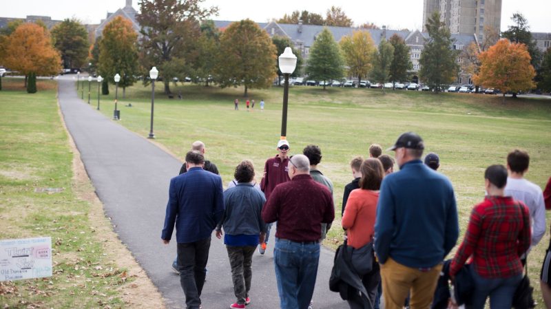 A group crosses the Drillfield during a campus tour.