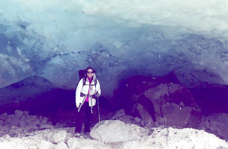 Virginia Tech student Jordyn Del Rosario poses near a glacier in the mountains of Chile as part of as student field work program
