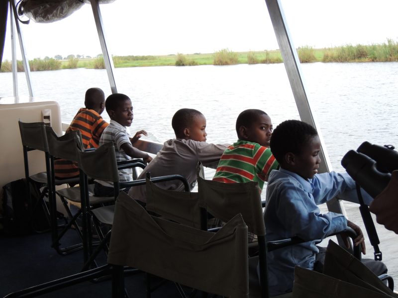 Students in the education program study the Chobe River. 