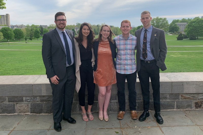 Members of the 2018-2019 Student Government Association standing outside with greenery in the background.