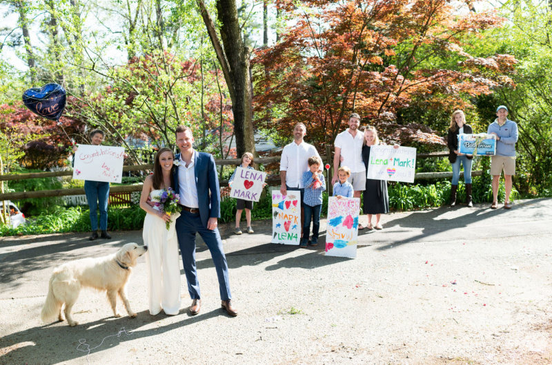 Lena and Mark had neighbors cheer on their wedding in a social distance way from the driveway