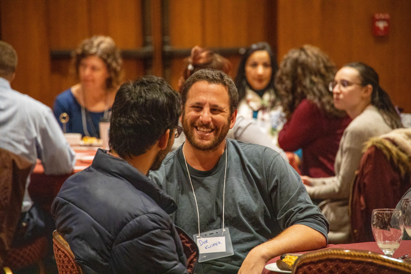 Two people laugh as they engage in conversation at the Interfaith Dialogue dinner. 