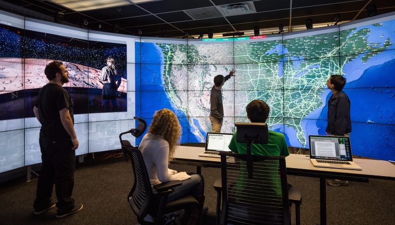 An example of SAGE2 at work, using cloud-based and web-browser technologies in order to enhance data intensive co-located and remote collaboration. Photo courtesy of Electronic Visualization Laboratory, University of Illinois at Chicago.