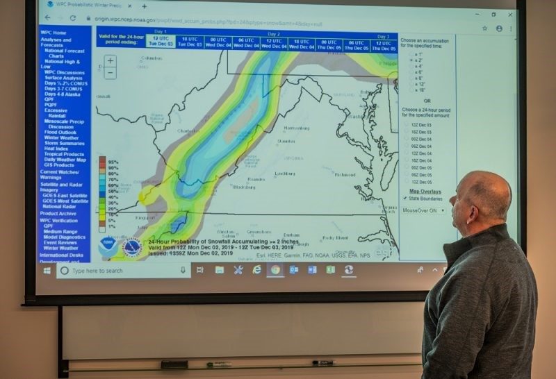 Man looks at a weather map