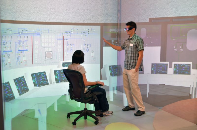 Two nuclear engineering students using a virtual reality system (VRS-RAPID) to view a spent fuel pool at a nuclear power plant.