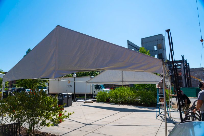 Crews install tents over designated outdoor spaces where students will be to study and work on projects between classes. Photo by Lee Friesland for Virginia Tech