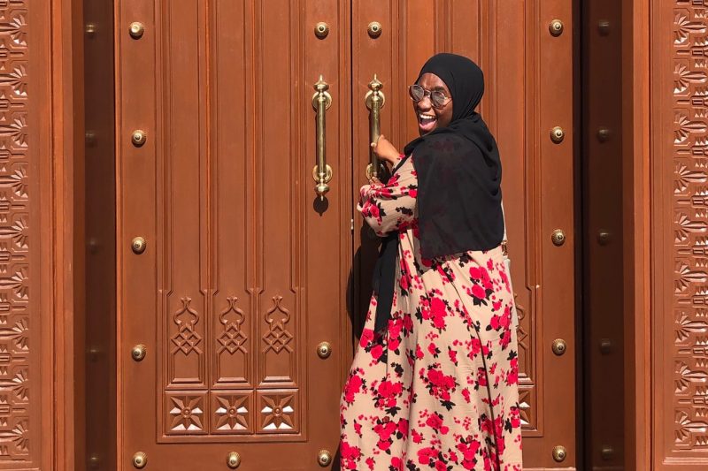 Sidiratu Bangura pulling open an ornate door