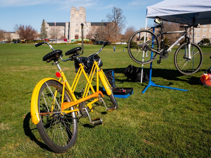 Bicycle resting on the Drillfield with Burruss in the background