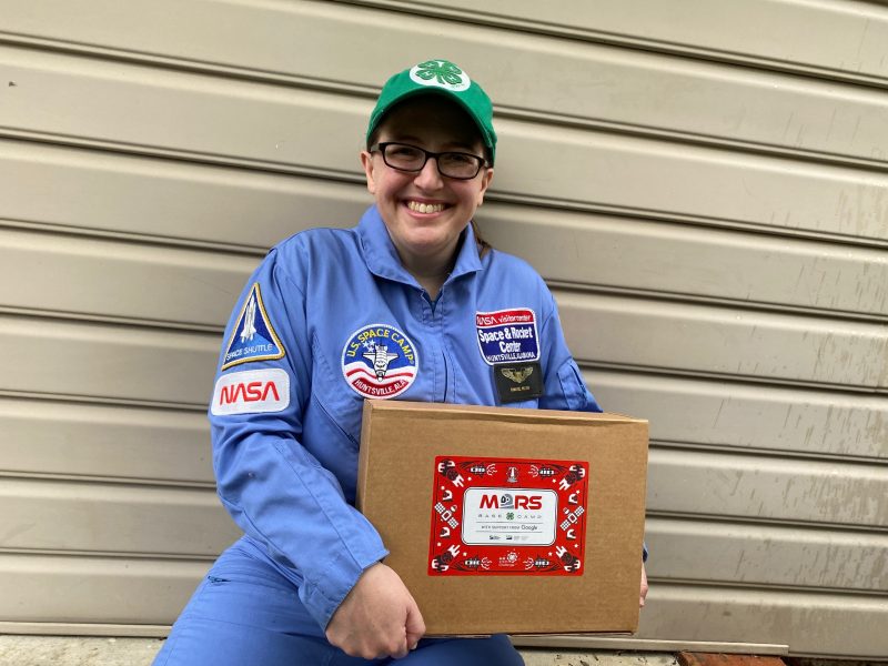 4-H Youth Development Specialist Chantel Wilson shows off one of the educational kits for the "Mission to Mars" STEM Challenge.