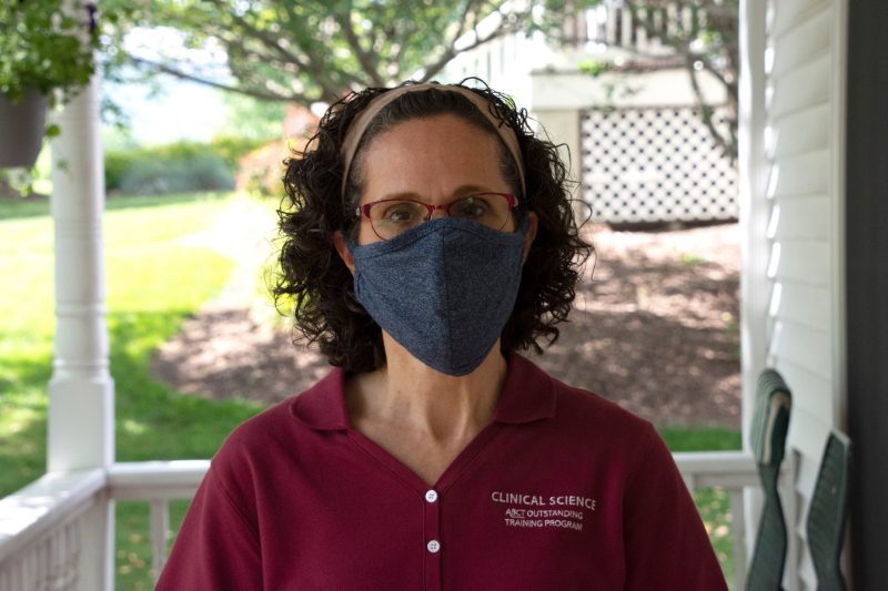 Angela Scarpa wearing a mask on her porch