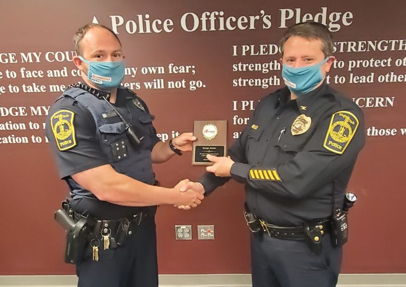 Officer Gymer poses with his award and Chief Mac Babb.