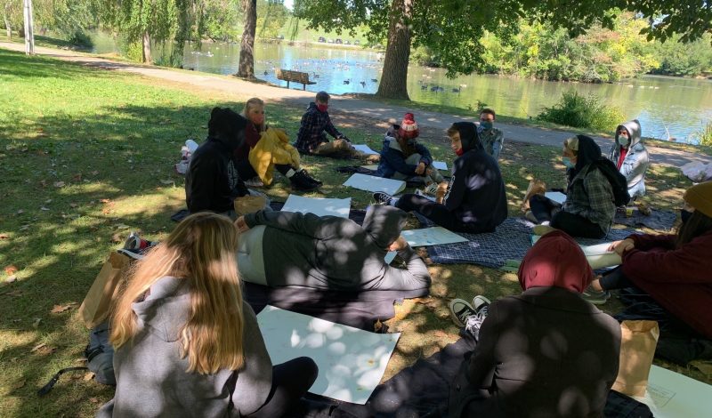 students sitting at Duckpond 