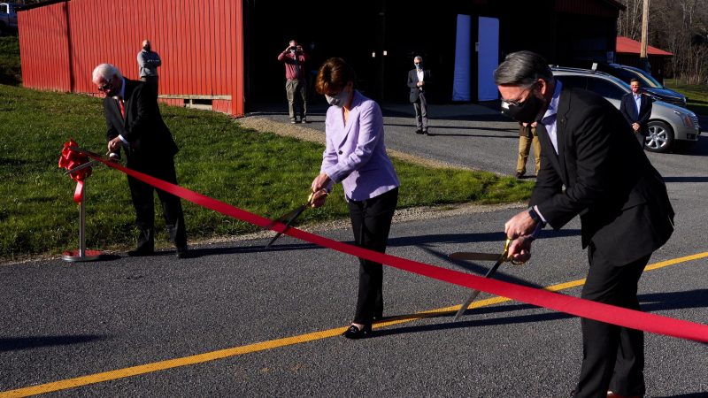 Dr. Tom Dingus, Catherine McGhee, and President Tim Sands get ready to cut the ribbon on the Rural Roadway.