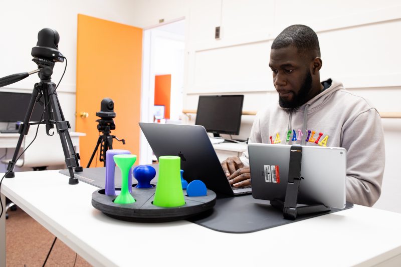 Kobla Setor Zilevu, a Virginia Tech computer science graduate student, works on the computer interface of the SARAH system in the Interactive Neurorehabilitation Lab. 