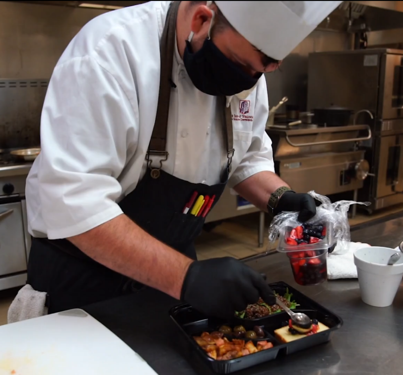 outreach-prestonssafety A chef filling a bento-style box