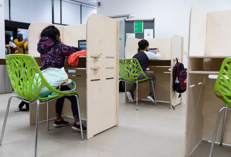 Children who take classes virtually and study at Casa Chirilagua, a non profit community organization in Alexandria, use desks donated by Building Momentum. Photo by Erin Williams for Virginia Tech.