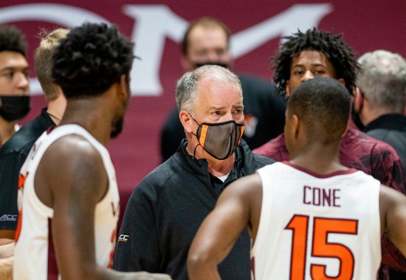 players and coach during basketball game