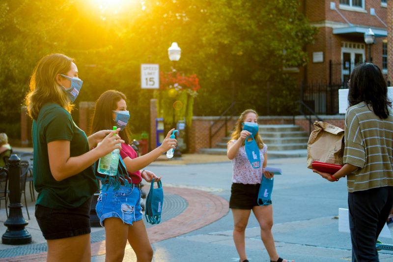 Virginia Tech students and COVID Crushers - Ashley Murray, Fernanda Gutierrez, and Jackie Abramson - hand out masks, hand sanitizer, and resources in downtown Blacksburg. The group spent Friday evenings this semester giving out personal protective equipment and medical-related information to help fight the COVID-19 pandemic.