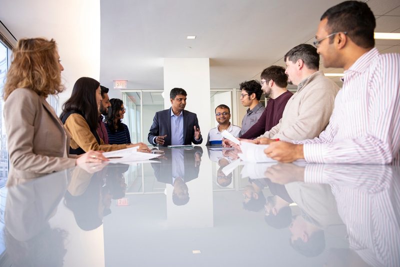 People sit around a conference table in a picture taken in early 2020.