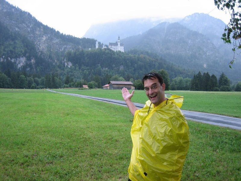 Photo of Hampton Clay Gabler III, professor in biomedical engineering and mechanics, standing in a yellow raincoat in front of tall, tree-covered mountains