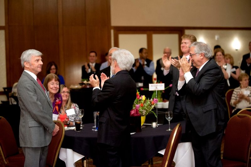 Sorensen and his wife Carol acknowledge the applause of Pamplin faculty and staff and other guests at his retirement reception in 2013. 