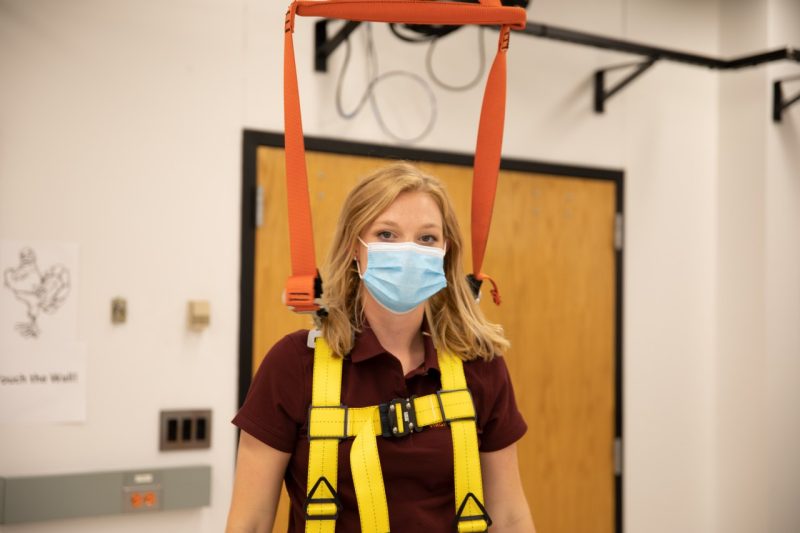Caitlin Bowman is strapped into the walking harness used to analyze her movement.