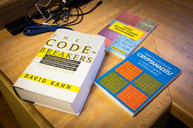 Three books about code breaking on a countertop.