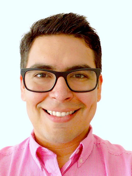 A headshot of Luis Zambrano-Cruzatty, a student in The Charles Edward Via, Jr. Department of Civil and Environmental Engineering, wearing glasses and a bright pink shirt.