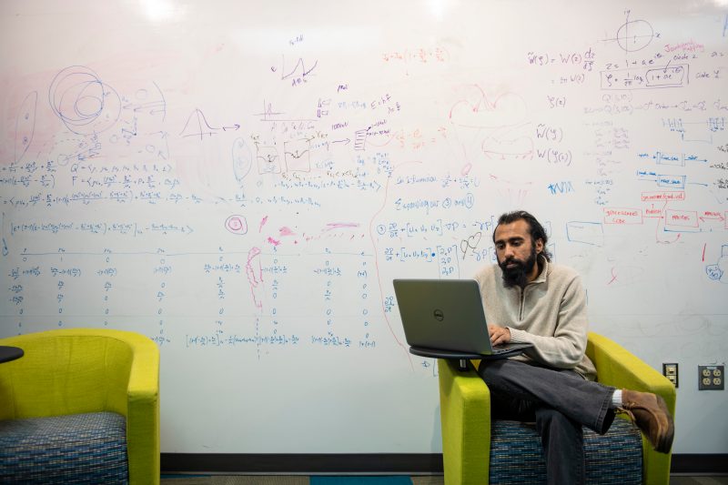 Aerospace engineering Ph.D. candidate Chirag Rathod works on his laptop