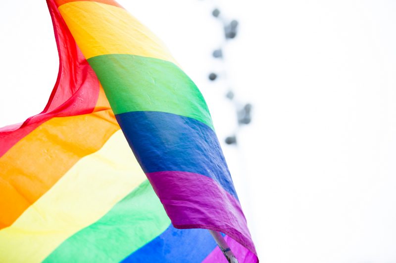 Image of LGBTQ flag flying 