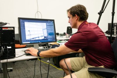 Student working in the cube on a computer.
