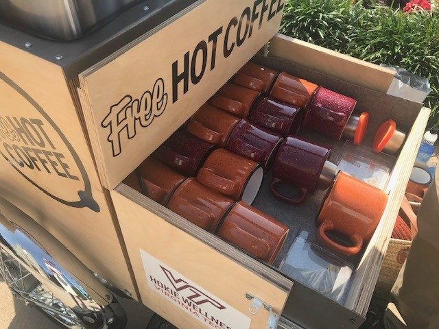 Coffee from the new e-trike is served in orange and maroon mugs. Photo by Jenny Boone.