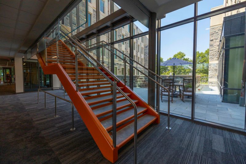 Bright orange staircase in CID lobby.