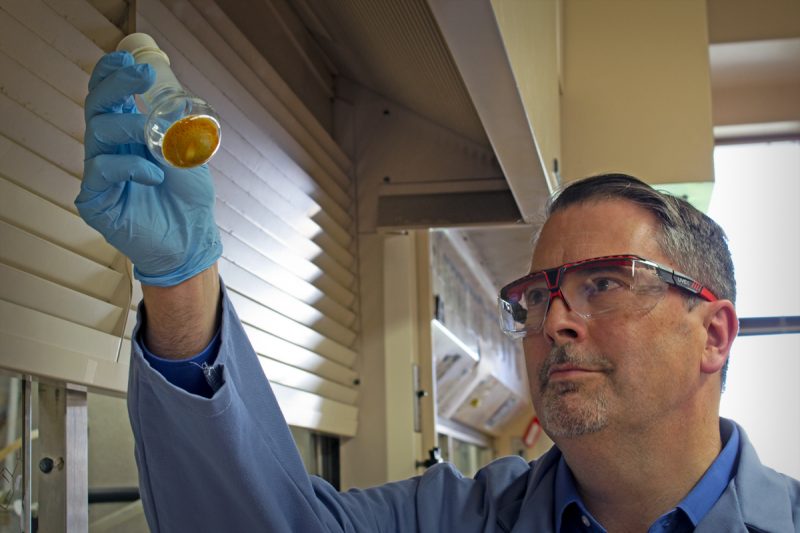 Paul Carlier, a professor in the Department of Chemistry in the Virginia Tech College of Science and Director of the Virginia Tech Center for Drug Discovery,  is holding a beaker.