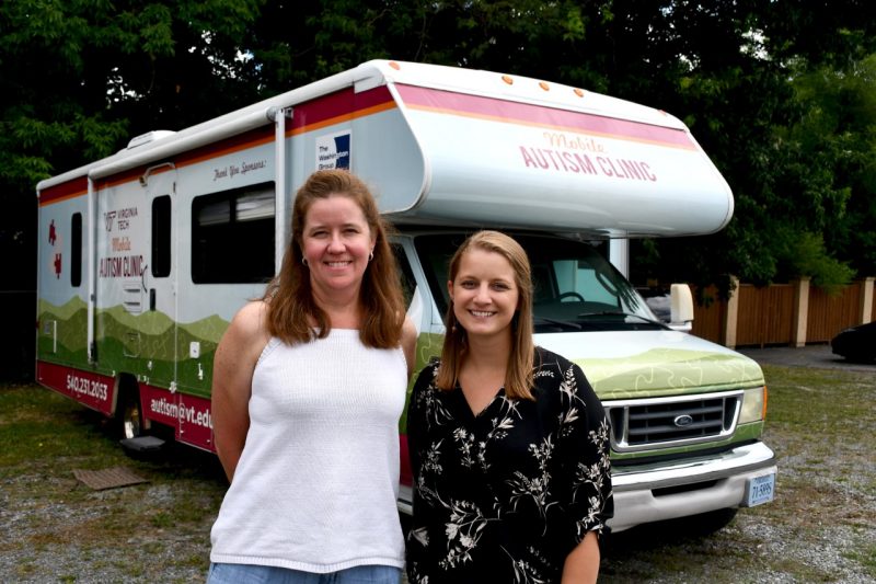 Left to right, Jen Scott and Jennifer Bertollo pose in front of the 94-foot-long Mobile Autism Clinic RV in Marion, Virginia. 