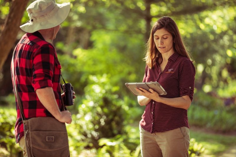Ashley Dayer, assistant professor in the Department of Fish and Wildlife Conservation in the College of Natural Resources and the Environment and an affiliate of the Global Change Center and the Center for Coastal Studies, speaks with someone as she types on her ipad.