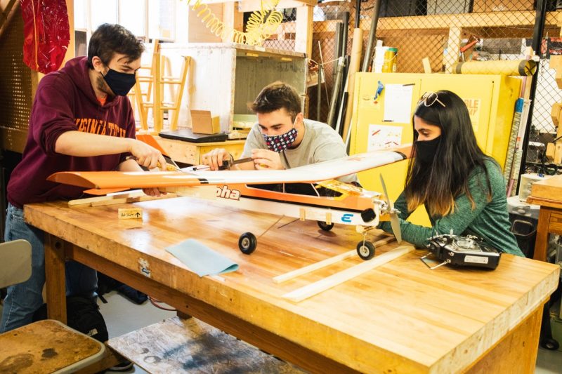 Members of the Design Build Fly student competition team work in the Ware Lab