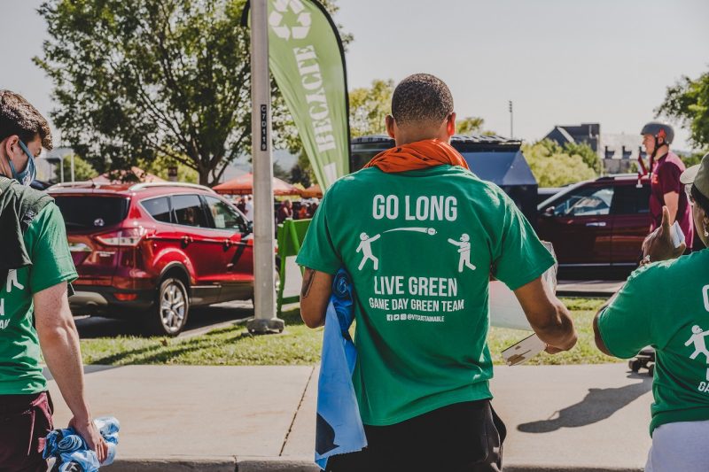 Three members of the Game Day Green Team educating tailgaters on recycling