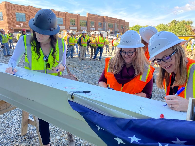Signing of final beam of Gilbert St. building
