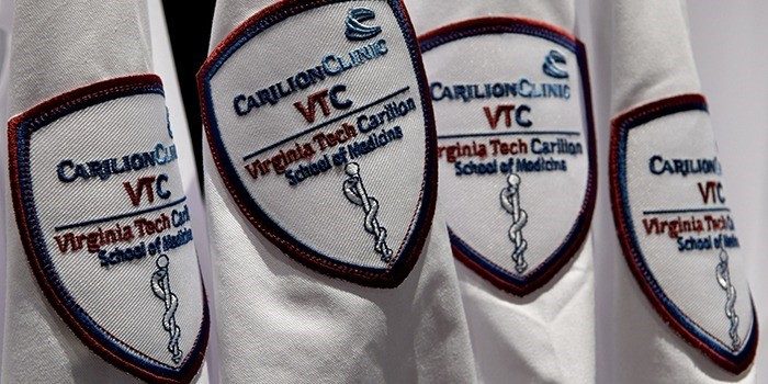 Line of four patches on medical white coats