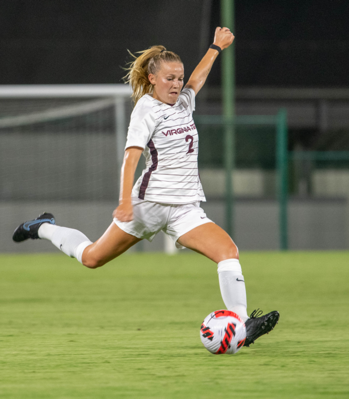 Riley McCarthy is a defender for the Virginia Tech’s women’s soccer team, shown kicking a soccer ball.