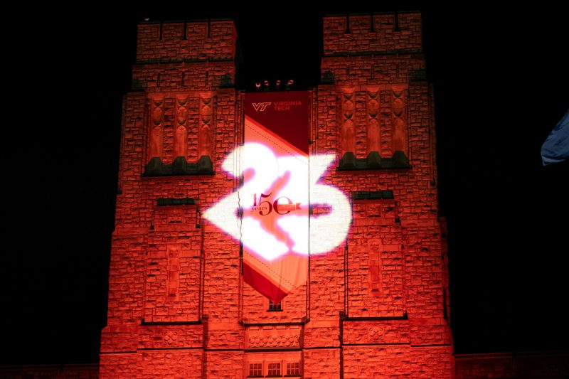 Burruss Hall lit up orange with Class of 2023 logo