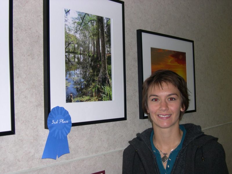 Image of Sarah Gugercin and her first place photo of trees and a stream
