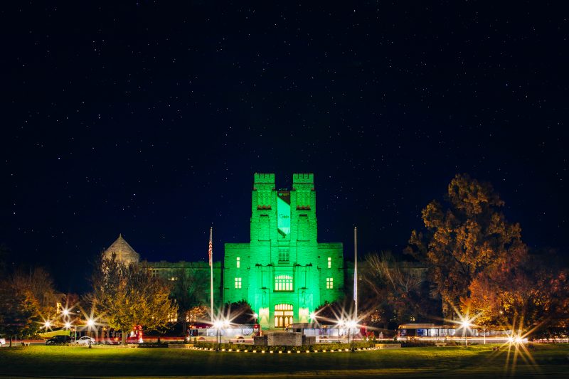 Burruss Hall is lit in green to honor veterans for Veterans Day