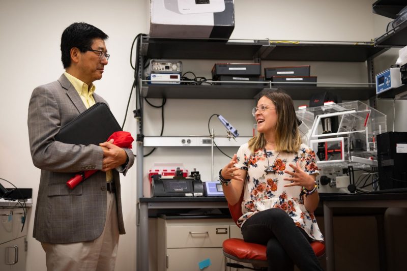 A Virginia Tech student talks with Dan Sui about her research in the Davalos Laboratory. Photo by Eleanor Nelson.