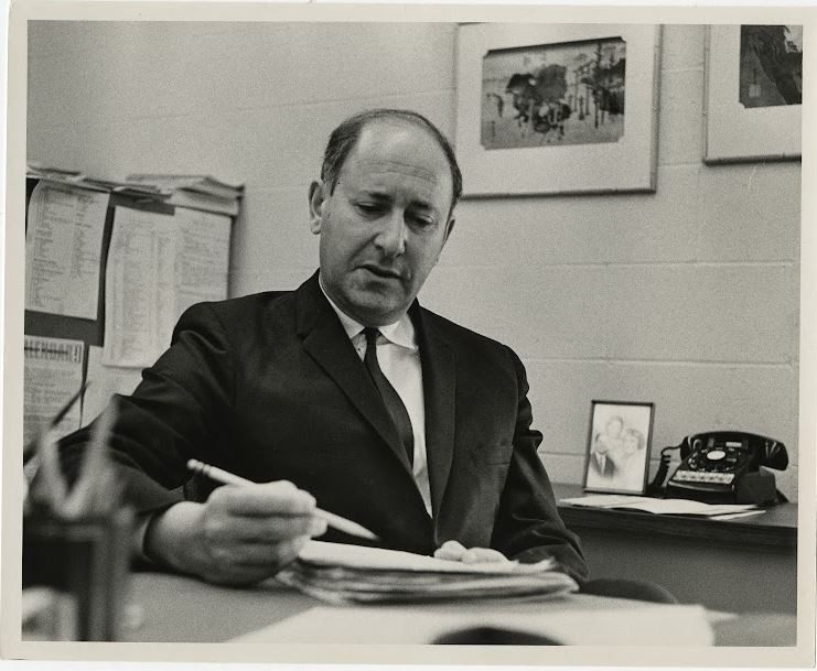 Robert E. Marshak is pictured working at his desk. Photo courtesy of Special Collections and University Archives, Virginia Tech.
